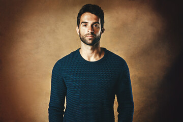 Portrait, serious and man in studio, fashion and warm in winter, confidence and sweater for...