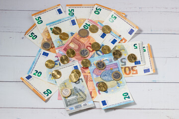 Euro banknotes and coins randomly arranged. Concept of economy, inflation, savings.