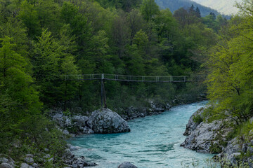 Caporetto, Slovenia. Kozjak waterfalls. Nature trail along the river with crystal clear, turquoise water, Tibetan bridges and a waterfall inside the cave with a nature pool. easy trekking, wood path.