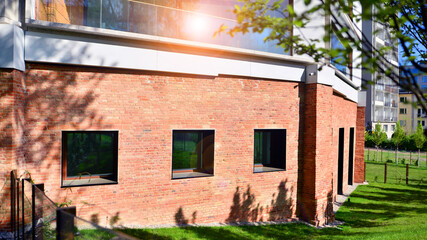 Eco architecture. Green tree and new residential building. Harmony of nature and modernity. Modern apartment building with new apartments in a green residential area.