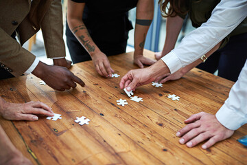 Puzzle, group and business hands with problem solving, collaboration and integration for project...