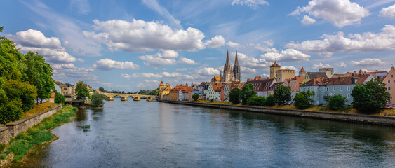 Panoramic view on beautiful Stone Bridge, Cathedral and Old Town. River Danube with colorful reflection, Regensburg, Bavaria, Germany. High quality photo