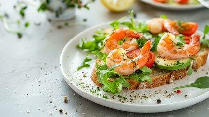 Delicious avocado toast with lemon, fresh greens, and shrimp on elegant white plate with spices