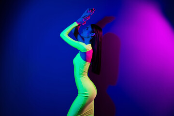 Obraz na płótnie Canvas Profile photo of charming fancy model girl posing raise hands empty space isolated on multicolor neon background