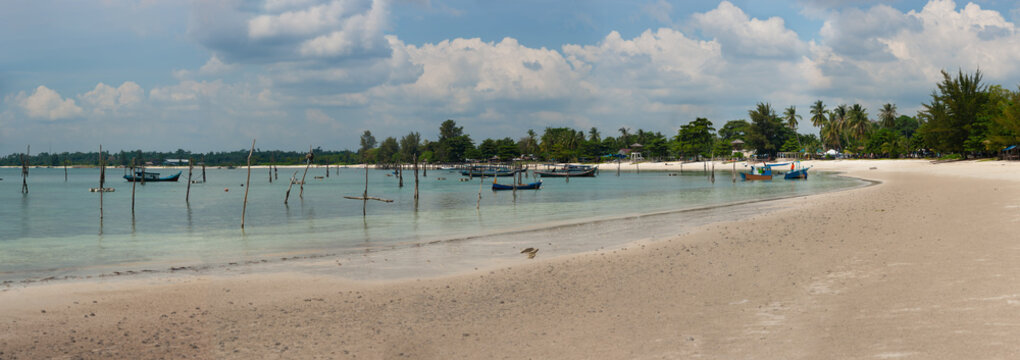 panoramic beach with fishing boats and calm, crystal-clear turquoise blue waters with granit&eacute; Stones in Tanjung Kelayang, Belitung, Bangka Belitung, Indonesia.(pan3)