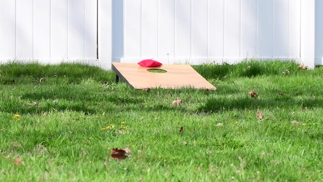 Corn hole practice play focus on the hole and bags