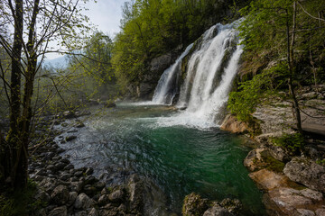 Bovec, Slovenia. Visje waterfalls. Nature trail crystal clear, turquoise water. easy trekking, nature experience, wood path. Waterfalls inside a forest, long photographic exposure, power of nature.