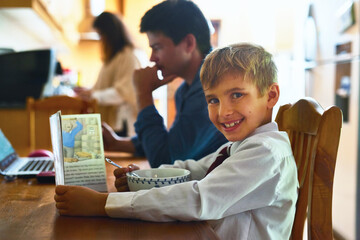 Portrait, child and book in home with breakfast for reading or learning with morning routine and...