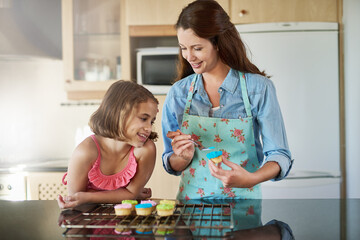 Mother, child and icing cupcakes for baking in home or dessert decorations, learning or bonding....