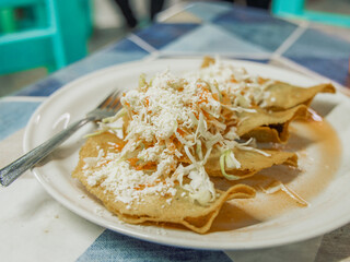 Close up view of traditional flautas served in Puerto Vallarta Mexico served on a plate on table.