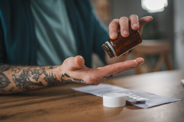 One adult man drink medicine drug tablet or supplement vitamin at home