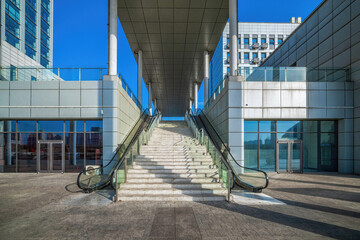 Sunlit Staircase Between Modern Glass Buildings