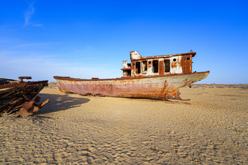 Rusty shipwreck lying on the seabed of the dried-up Aral Sea in Moynaq (or Muynak), a former fishing town in Karakalpakstan, Uzbekistan