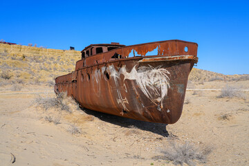 Rusty shipwreck lying on the seabed of the dried-up Aral Sea in Moynaq (or Muynak), a former...