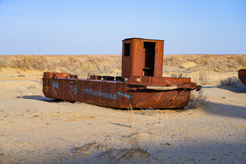 Rusty shipwreck lying on the seabed of the dried-up Aral Sea in Moynaq (or Muynak), a former...