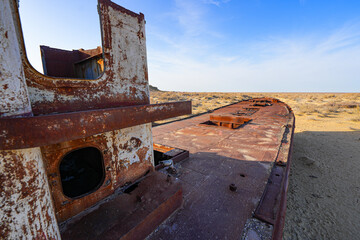 Rusty shipwreck lying on the seabed of the dried-up Aral Sea in Moynaq (or Muynak), a former...