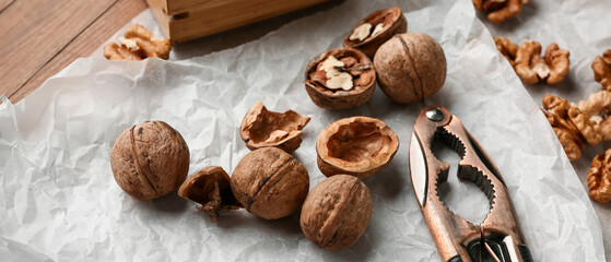 Tasty cracked walnuts on table