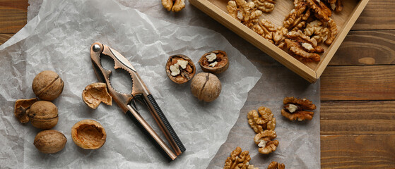 Box of tasty walnuts on wooden background