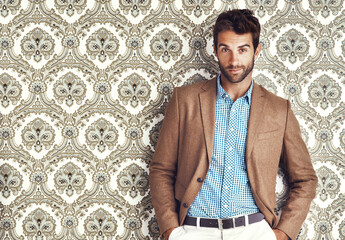 Portrait, confidence and man in suit for fashion on a vintage wallpaper background isolated in...