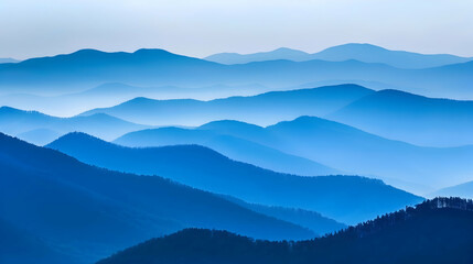 A rugged mountain ridge at dusk, captured with a telephoto lens to compress the distance and enhance the layering effect of the mountains