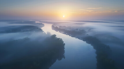 Naklejka premium A secluded river winding through a thick mist at dawn, captured with a wide-angle lens for a sweeping view