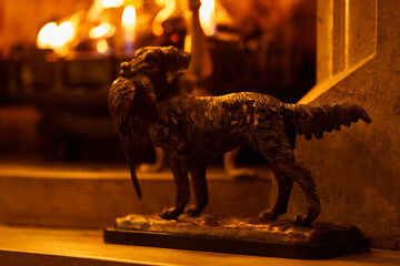hunter dog statue beside fireplace