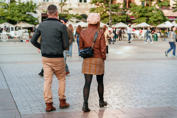 A couple in a vibrant city square, showcasing 2024 urban exploration trend, perfect for concepts of...