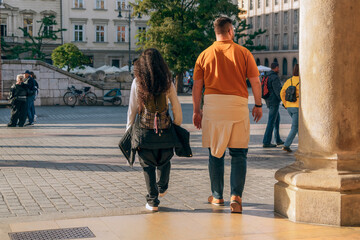 A Gen Z couple strolls through a European city square, hinting at themes of travel, romance and...