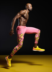 Athletic man in motion on a dynamic studio background