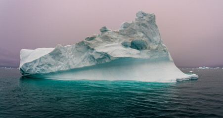 solitary iceberg aqua water in Ilulissat Greenland