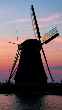 Windmills at famous tourist site Kinderdijk in Holland on sunset with dramatic sky. Kinderdijk , Netherlands