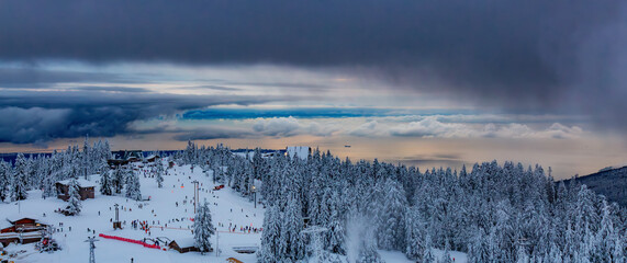 Grouse Mountain during cloudy sunset. Winter Season.