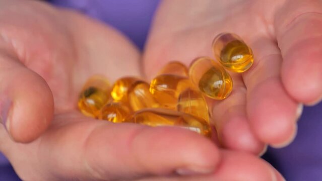 Omega fatty acids.Fish oil Fish oil capsules in female hands.Healthy fats and womens health.Fish oil for womens health.omega fatty acids.Natural supplements and vitamin
