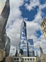 downtown manhattan skyline view (wide angle photo with one world trade center skyscraper in the middle) financial district new york city famous landmark travel destination glass reflecting blue sky - obrazy, fototapety, plakaty