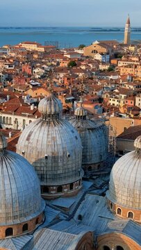 View of Venice with St Mark's Basilica and square and Doge's Palace on sunset from St Mark's Campanile bell tower, Venice, Italy. Camera horizontal pan