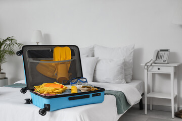 Interior of hotel room with suitcase on bed