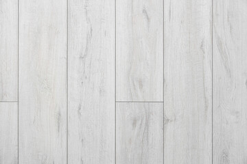 Light wooden laminate floor as background, closeup