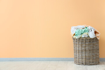 Full laundry basket near color wall