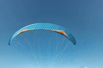 Colorful paraglider close-up against the blue sky