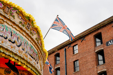 Detail of the upper part of a carousel, on which the British flag is anchored. In the background is...