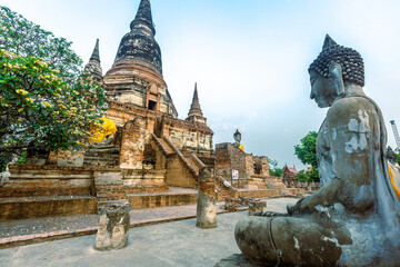 The background of important religious attractions, Wat Yai Chai Mongkhon, has an old Buddha statue and a large pagoda for tourists to study the history of Ayutthaya in Thailand. - obrazy, fototapety, plakaty
