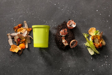 Bin, organic waste and soil on grey grunge background. Compost recycling concept