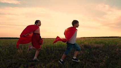 Superhero child. Boy girls in red cloak, Child dreams of becoming superhero. Happy girls, boy kids...