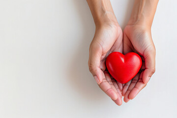 Cupped Hands Gently Holding a Glossy Red Heart, Symbolizing Care and Compassion on a Neutral Background