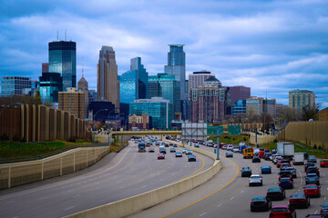 Minneapolis City Skyline and buildings in Minnesota, USA, Entering Downtown Traffic on I-94 on a stormy spring evening