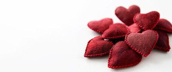 Red hearts shaped like love quotes in a style that incorporates fabric use, selective focus, and a white background.
