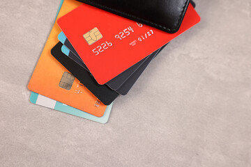 Pile of different credit cards on grey table, top view. Space for text - obrazy, fototapety, plakaty