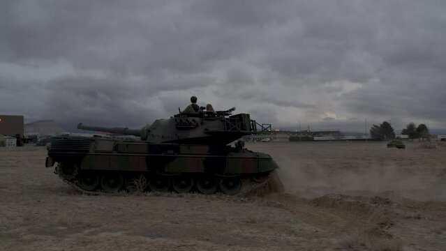 Epic shot of large battle tank in dirt field - drone shot