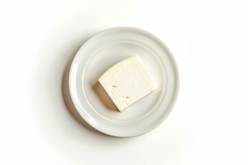 White cheese in saucer on white background top view flat lay