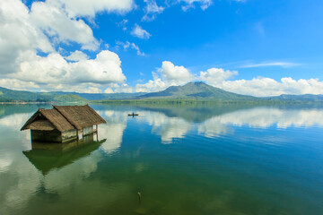 Beautiful Lake Batur landscape overlooking serene and beautiful Mount Batur during blue sky cloudy day